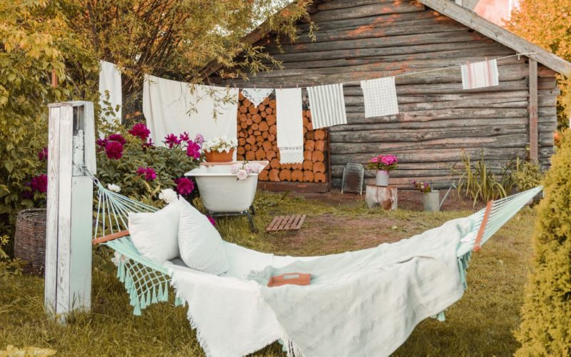 Place for washing and drying clothes, shoes and clothes on the street in the courtyard of a village house. The bathroom is outside in the courtyard, and the place of rest is a hammock. The concept of autumn